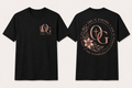 She Is Strong rose gold front and back black T-shirts shown in standardized Large fit